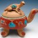 Turtle made for the 1974 Santa Fe Indian Market. Around the sides are sgraffito deer and lizards alternating with nine inset Indian Mountain turquoise.  The three bands of shell hei-shi and single strand of turquoise define the edge of lid.  The lid is one piece with a sculpted lizard rising off the surface and two pieces of turquoise inset on its back.  Signature:  DA, Lid:  DA Santa Fe Indian Market 1974.  10”w x 8”w x 8”h.  Collection of Roz and Gene Meieran.