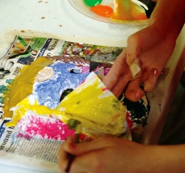 A class participant adds color to her mask.